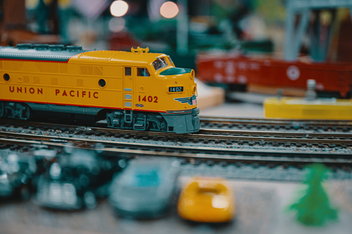 A yellow colour toy train on the track